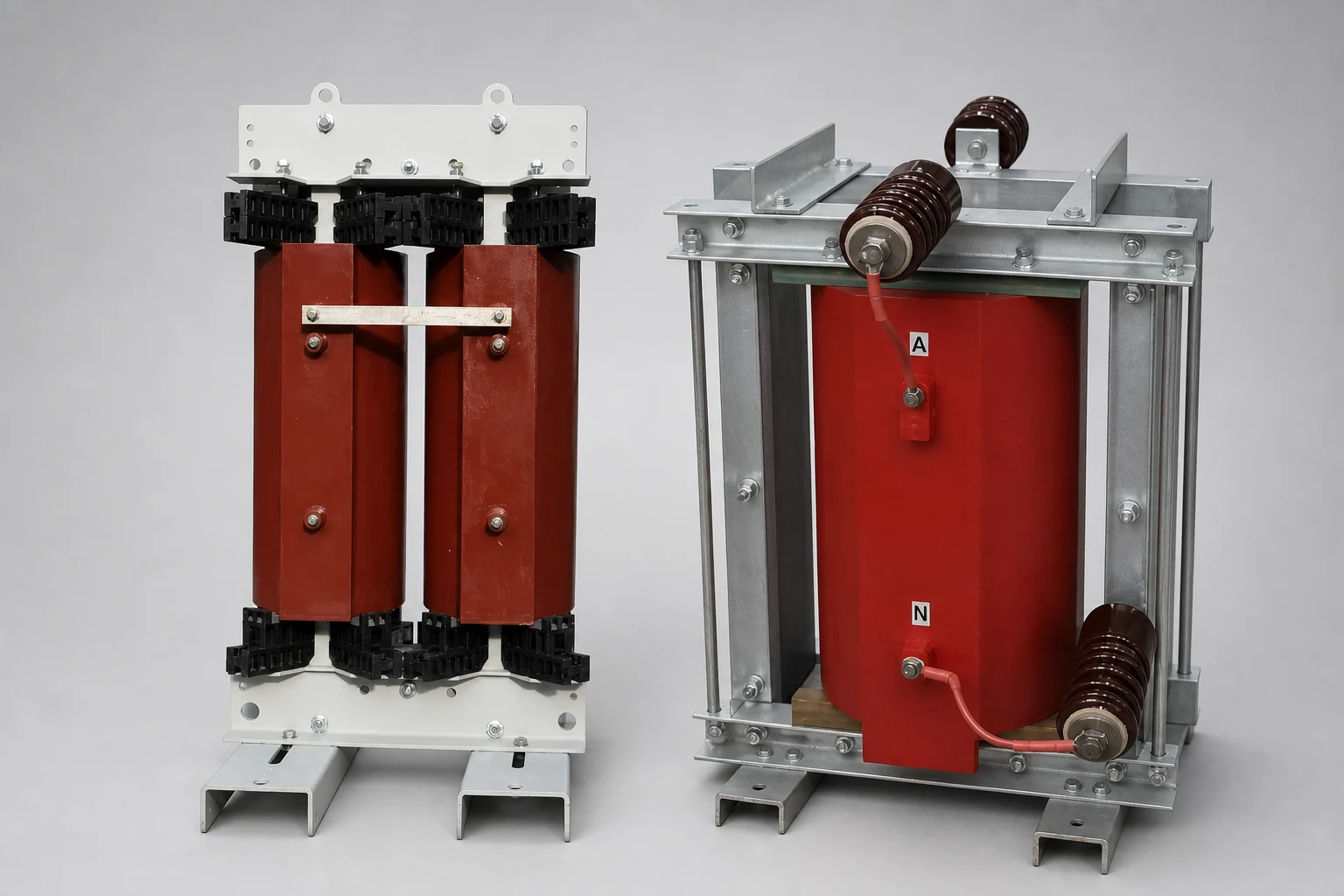Two dry type grounding transformer units with red cast resin coils, the right one with porcelain bushings