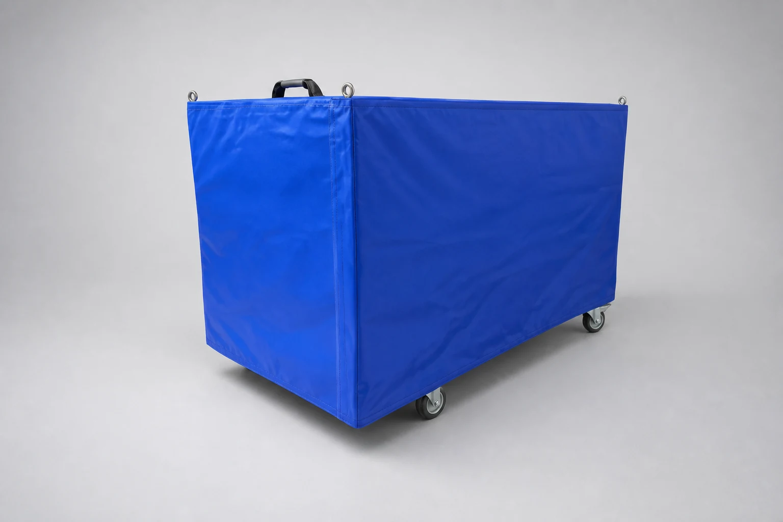Blue weatherproof protection cover over a load bank on castors, with lifting eyes and a carry handle