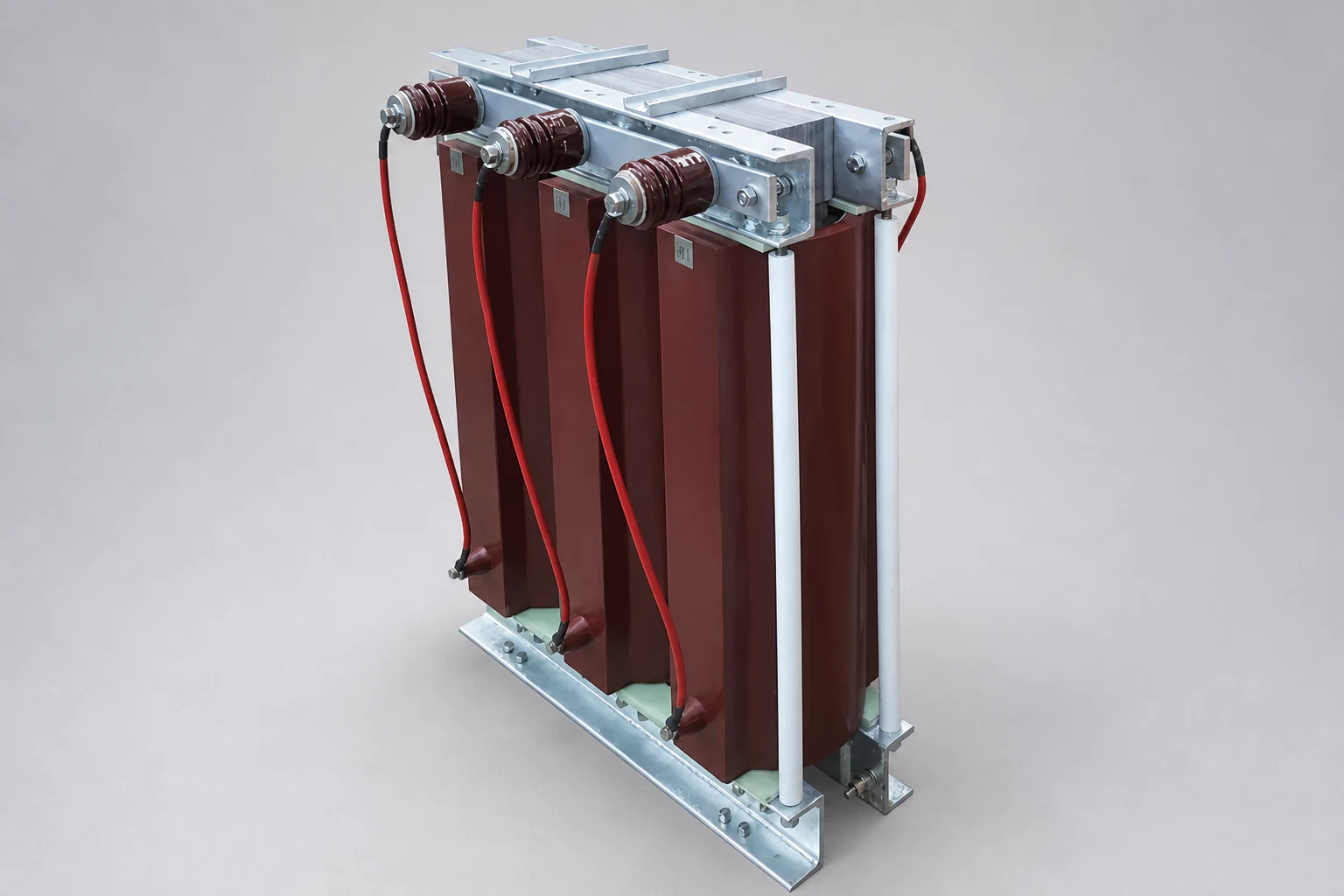 Three-phase iron-core motor-starting reactor with three red-brown windings, porcelain bushings and galvanized steel frame