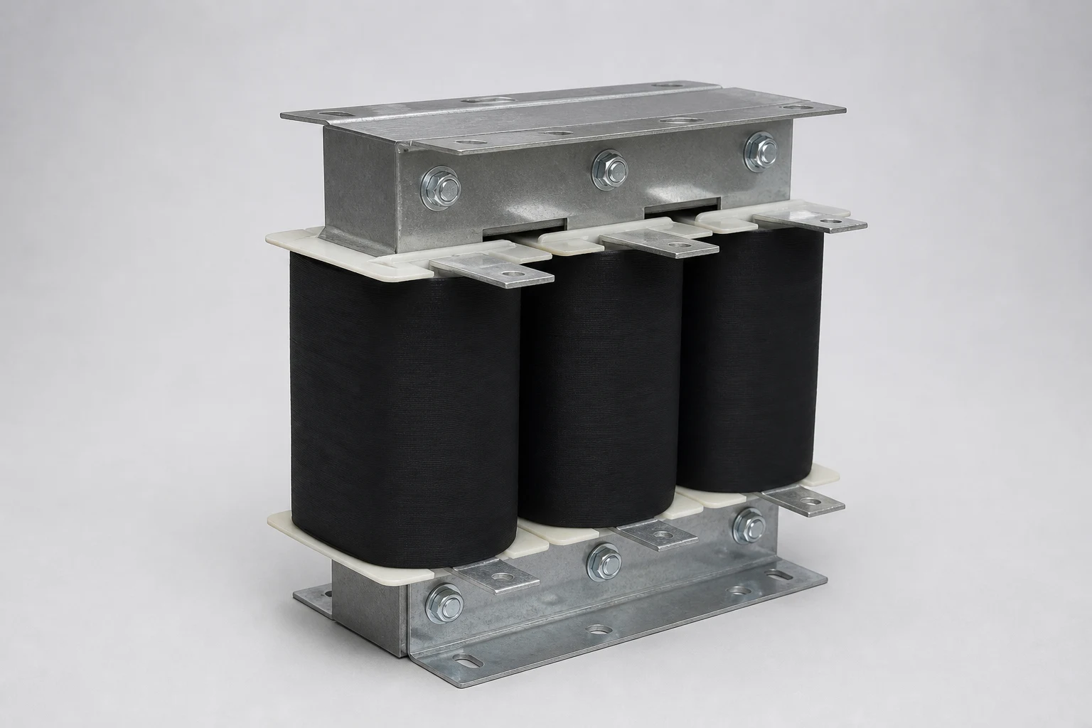 Three-phase iron-core motor-starting reactor with three black windings and galvanized steel frame