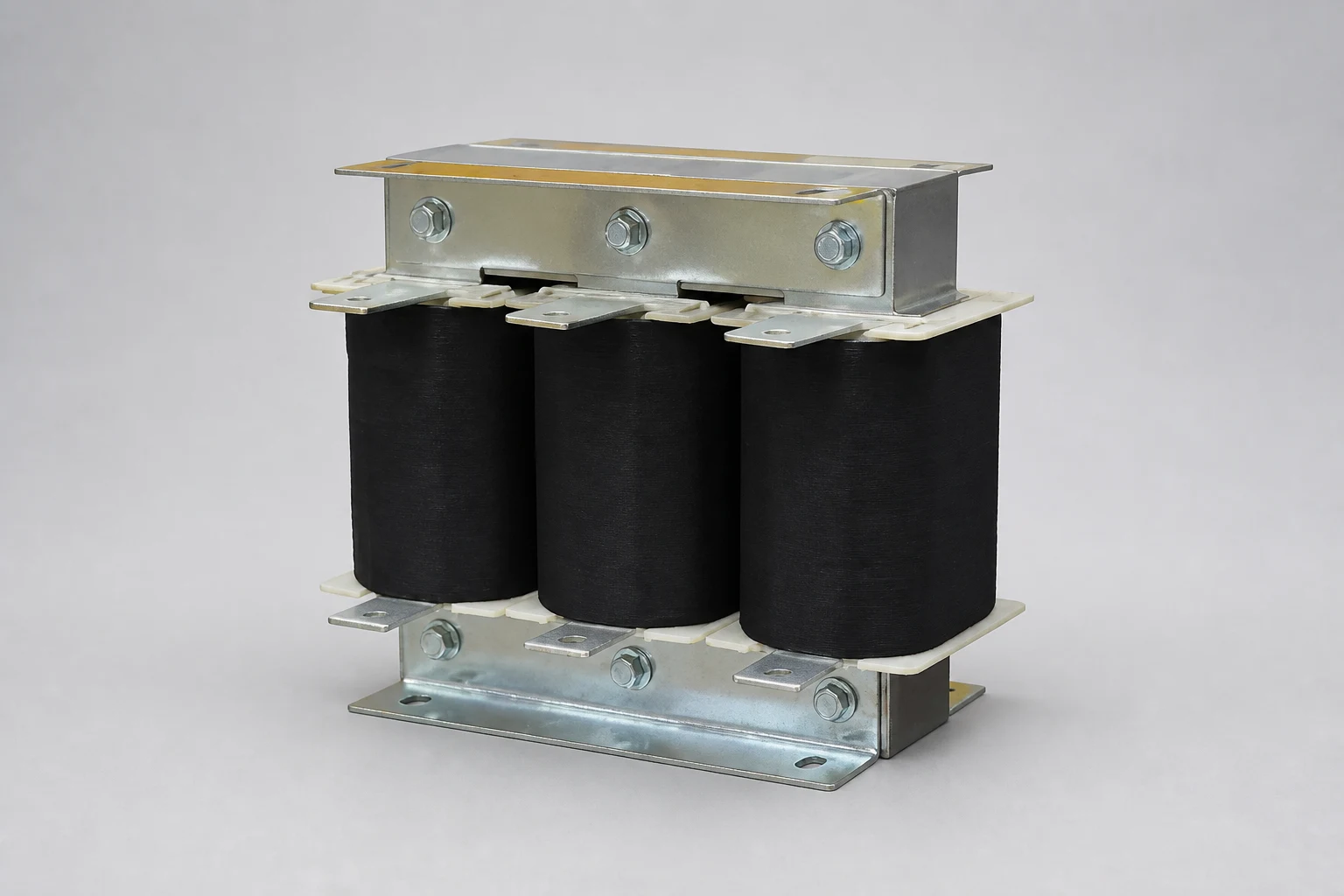 LV three-phase iron core reactor with three coils, flat terminal lugs and a galvanized steel clamping frame